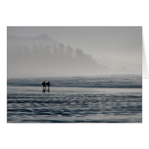 Surfers in the mist.