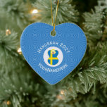 Swedish Angel Hanukkah Flag Personalised  Ceramic Ornament<br><div class="desc">The blue and yellow Flag of Sweden is worn by an angel on this heart shaped ceramic ornament for holiday and Hanukkah decor. It is designed for families of multiple religions. The Swedish Flag Hanukkah Angel is found inside a circle of white squiggly squares that is surrounded by a background...</div>