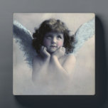 Sweet Rosy Cheeked Vintage Angel in Clouds Plaque<br><div class="desc">Beautiful vintage design of a sweet angel with soft white wings and rosy cheeks,  holding her face in her hands. Looking peaceful and kind. The background is filled with soft ethereal clouds.</div>