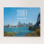 Sydney Harbor Bridge & Opera House, 520 pieces Jigsaw Puzzle<br><div class="desc">Welcome to one of the world’s most beautiful natural harbors. Sydney Harbor has it all; sparkling blue waters, iconic tourists attractions, hidden beaches, pristine bushland, pretty botanic gardens brimming with native flora and charming islands that are made for exploring. Hop on a ferry at Circular Quay and glide past the...</div>