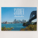 Sydney Harbour Bridge & Opera House, 1014 pieces Jigsaw Puzzle<br><div class="desc">Welcome to one of the world’s most beautiful natural harbours. Sydney Harbour has it all; sparkling blue waters, iconic tourists attractions, hidden beaches, pristine bushland, pretty botanic gardens brimming with native flora and charming islands that are made for exploring. Hop on a ferry at Circular Quay and glide past the...</div>