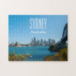 Sydney Harbour Bridge & Opera House, 252 pieces Jigsaw Puzzle<br><div class="desc">Welcome to one of the world’s most beautiful natural harbours. Sydney Harbour has it all; sparkling blue waters, iconic tourists attractions, hidden beaches, pristine bushland, pretty botanic gardens brimming with native flora and charming islands that are made for exploring. Hop on a ferry at Circular Quay and glide past the...</div>