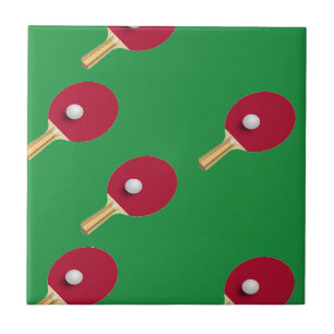 Table tennis racket and ball on green ceramic tile