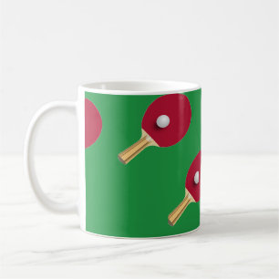 Table tennis racket and ball on green coffee mug