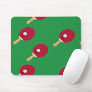 Table tennis racket and ball on green mouse pad