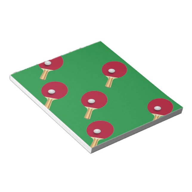 Table tennis racket and ball on green notepad (Angled)