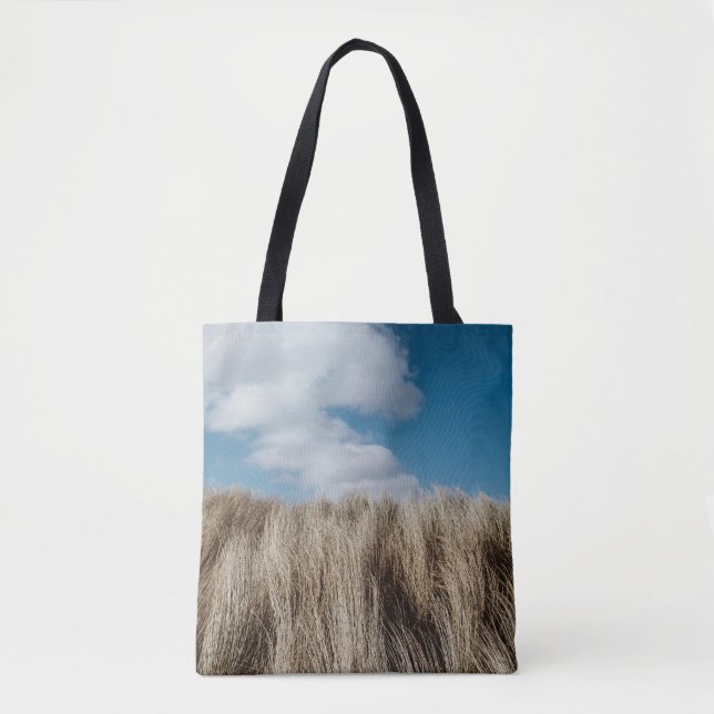 Tall grass under cumulus clouds tote bag (Front)