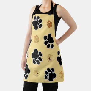 Tan and black paw print on a gold background  apron