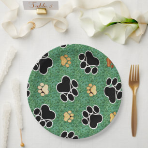 Tan and black paw print on green grass paper plate