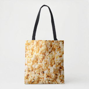 Tasty popcorn on whole background. Food  Tote Bag