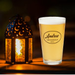 Taupe Stylised Wedding Groomsman Name Glass<br><div class="desc">Beer glass for the wedding groomsman that features his name printed in a taupe colour,  stylised script inside a taupe colour oval border along with wedding date. A great party supply idea for a bachelor party! Personalise your beer glass by editing and replacing name and date with your own.</div>