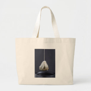 Tea bag is hung in a cup