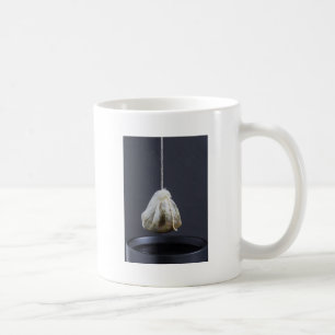 Tea bag is hung in a cup