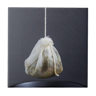 Tea bag is hung in a cup ceramic tile