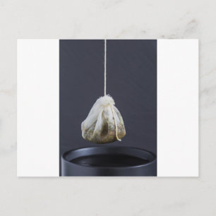 Tea bag is hung in a cup postcard
