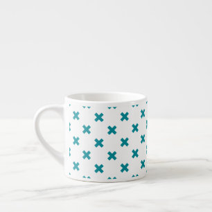 Teal cross stitches on white espresso cup