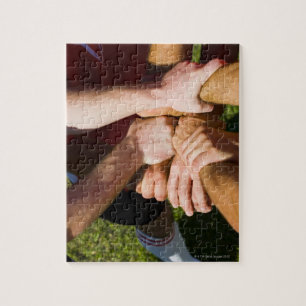 Team with arms-in jigsaw puzzle