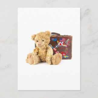 teddy bear and vintage old suitcase with world sti postcard