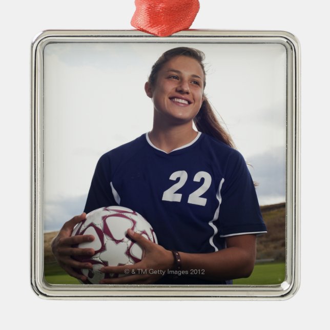 teen girl soccer player holding soccer ball metal ornament (Front)