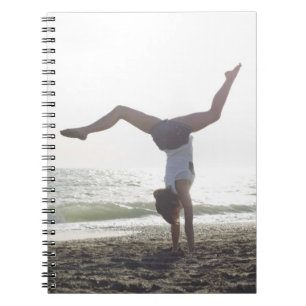 Teenage girl performs gymnastic feat, mum notebook
