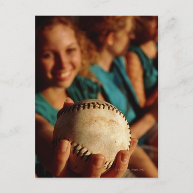 Teenage girls' softball team sitting in dugout postcard (Front)