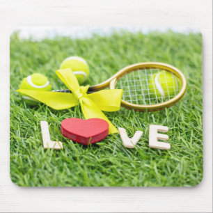 Tennis ball and racket on green grass with love   mouse pad