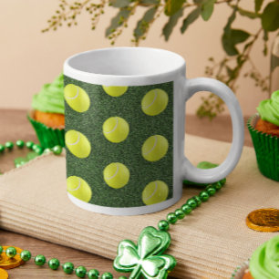 Tennis ball on green grass coffee mug