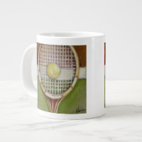 Tennis Racket with Ball Laying on Court