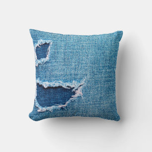 Textured denim background. Torn hole in the fabric Cushion