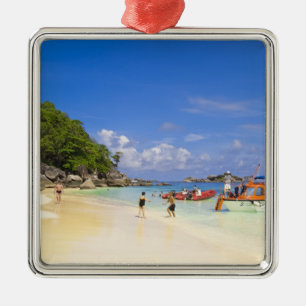 Thailand, Andaman Sea. Passengers onshore at Metal Tree Decoration