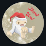 Thank You with a Christmas Snow Monster Toy Doll Classic Round Sticker<br><div class="desc">A thank you sticker with an illustration of a cute little Christmas snow monster toy doll, wearing a red santa hat. The little snow creature has a pull string to make him talk and he is covered in soft white fur with light brown accents. Background is a taupe brown colour...</div>