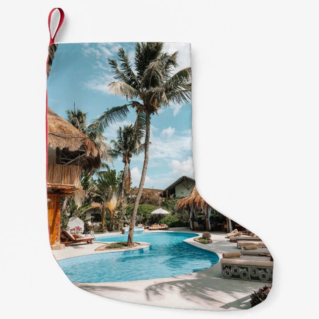 Thatch huts and houses by the pool during day small christmas stocking (Front)