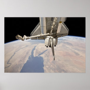 The aft section of the docked space shuttle poster
