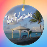 The Bahamas Commemorative Ceramic Ornament<br><div class="desc">The Bahamas commemorative ornament to celebrate happy memories of your tropical Caribbean vacation. Photo of a lovely beach scene with a cabana and palm tree,  along with The Bahamas in fun typography. Choose your ornament shape.</div>