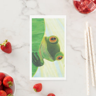 The big-eyed green frog behind lily pad napkin