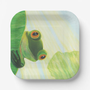 The big-eyed green frog behind lily pad   paper plate