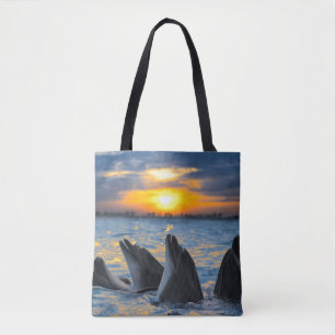 The bottle-nosed dolphins in sunset light tote bag