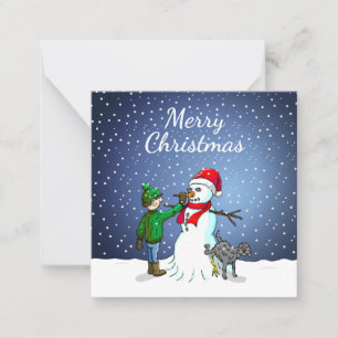 The boy is making a snowman card