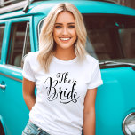 The Bride Black Script Personalised Wedding T-Shirt<br><div class="desc">The Bride wedding shirt features modern black swirling calligraphy script writing with elegant custom Future Mrs text that you can personalise with a last name on the reverse side. See our coordinating bridal party designs!</div>