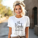 The Bride Black Script Personalised Wedding T-Shirt<br><div class="desc">Wedding The Bride shirt features modern black swirling calligraphy script writing with elegant custom first name text that you can personalise. See our coordinating bridal party designs!</div>