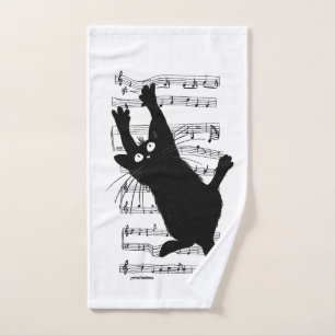 The cat hangs on musical notes bath towel set