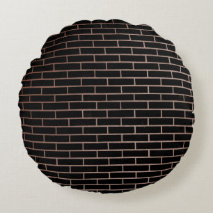 The dark black brick wall has a rough surface as a round cushion