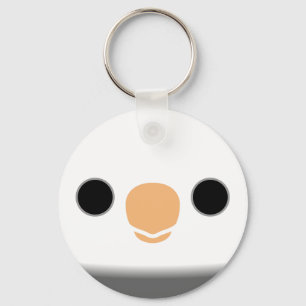 The face of a white-faced pied male cockatiel key ring