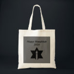The Flame & Star - Tote Bag<br><div class="desc">This image is a flame from a candle. A star around the flame represents Hanukkah. Done in a black tattoo. A black backround was also added. "Happy Hanukkah 2014" is printed on this design. Customise with your own words. These totes are available in assorted styles, colours and sizes.</div>