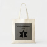 The Flame & Star - Tote Bag<br><div class="desc">This image is a flame from a candle. A star around the flame represents Hanukkah. Done in a black tattoo. A black backround was also added. "Happy Hanukkah 2014" is printed on this design. Customise with your own words. These totes are available in assorted styles,  colours and sizes.</div>