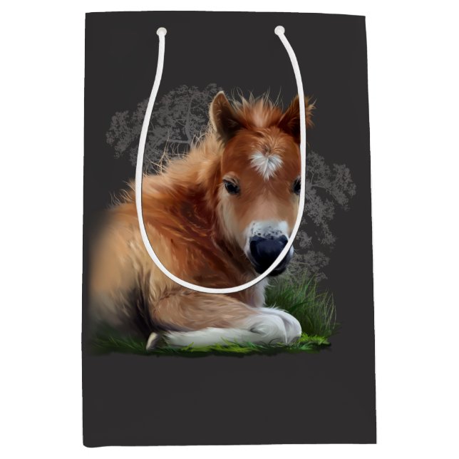 The foal is lying in the grass medium gift bag (Front)