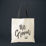 The Groom | Script Style Custom Name Wedding Tote Bag<br><div class="desc">Make the groom feel extra appreciated with this special custom name canvas style tote bag.
 
 It features the words "the groom" in an elegant script style text. Underneath this is a spot for his name or initials above a leaf ornamental.</div>