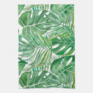 The huge leaves of palm trees and monstera tea towel