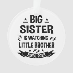 The little sister takes care of the big brother in ornament