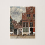The Little Street by Johannes Vermeer Jigsaw Puzzle<br><div class="desc">The Little Street by Johannes Vermeer, oil on canvas 1657-1658, is a sunny landscape painting of cobblestoned street, building facades, and women performing chores in Vermeer’s home city of Delft. The fine details of red brick houses, glasswork, vines and stucco are painstakingly executed against a backdrop of blue sky and...</div>